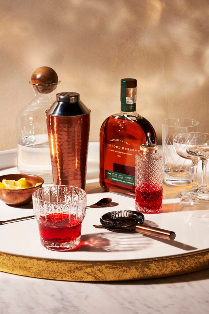Woodford Reserve Kentucky Straight Rye Whiskey bottle on a gold lined white tray with the Old Pal cocktail.